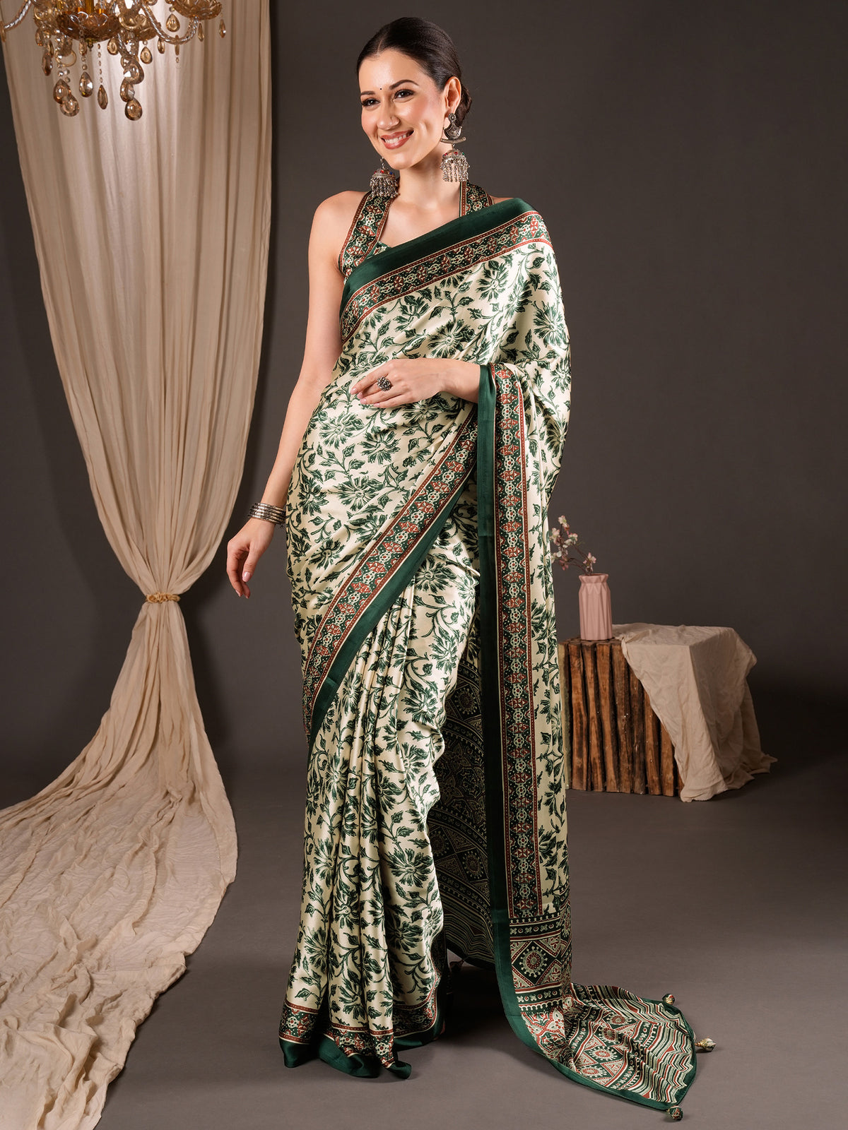 Woman wearing cream satin saree with ajrak block-print motif work and green blouse