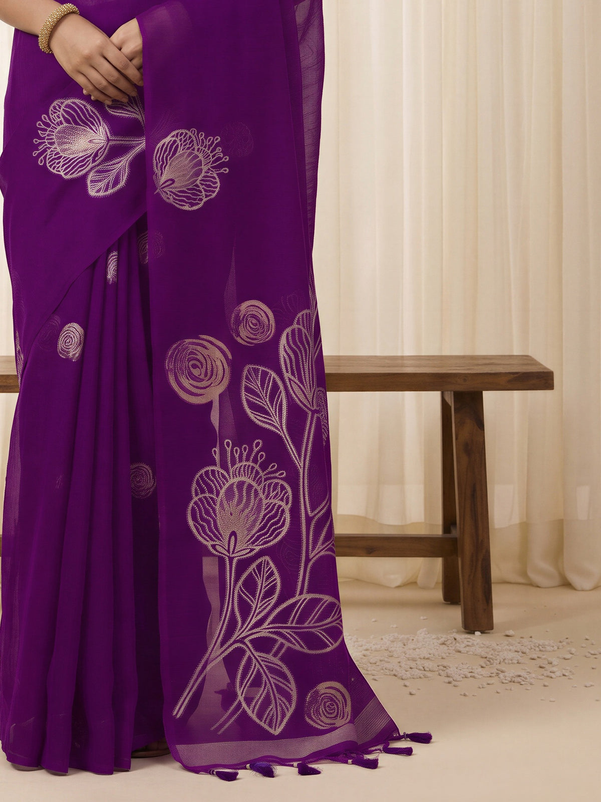 Pallu detail of purple pure silk saree showing all-over floral design and solid border