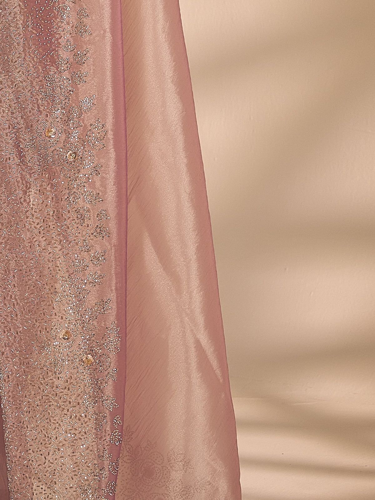 Pallu detail of pink organza saree showing applique design and embellished border