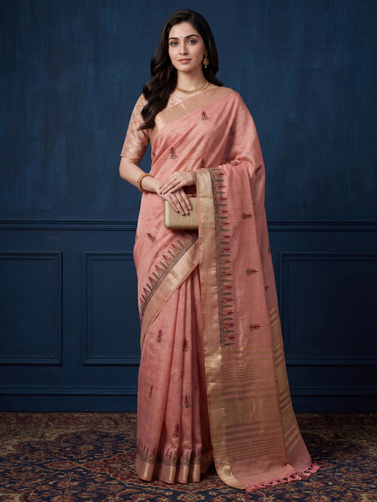 Woman wearing pink cotton linen saree with embroidered motif work and pink blouse