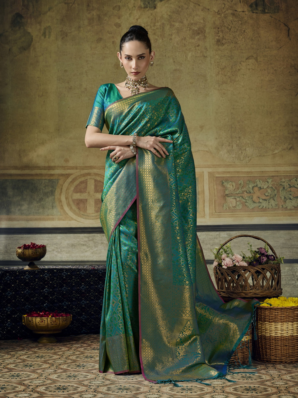 Woman wearing teal blue pure silk saree with woven motif design and teal blue blouse