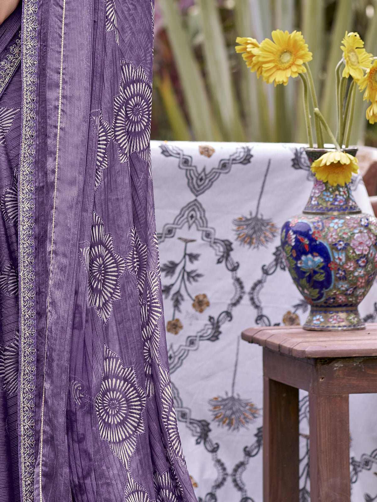 Pallu detail of purple chiffon saree showing traditional indian motif work and embellished border