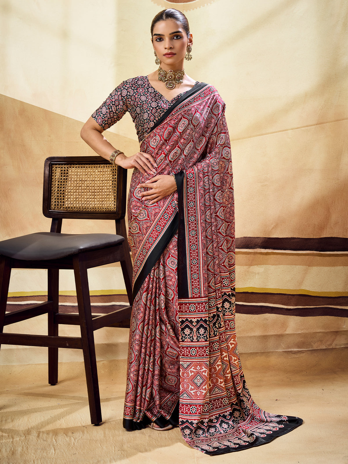 Woman wearing maroon satin saree with ajrak block-print motif work and black blouse