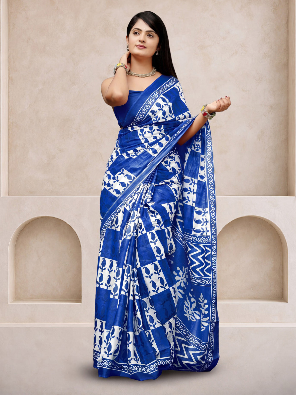 Woman wearing blue cotton saree with dabu mud-resist print work and blue blouse