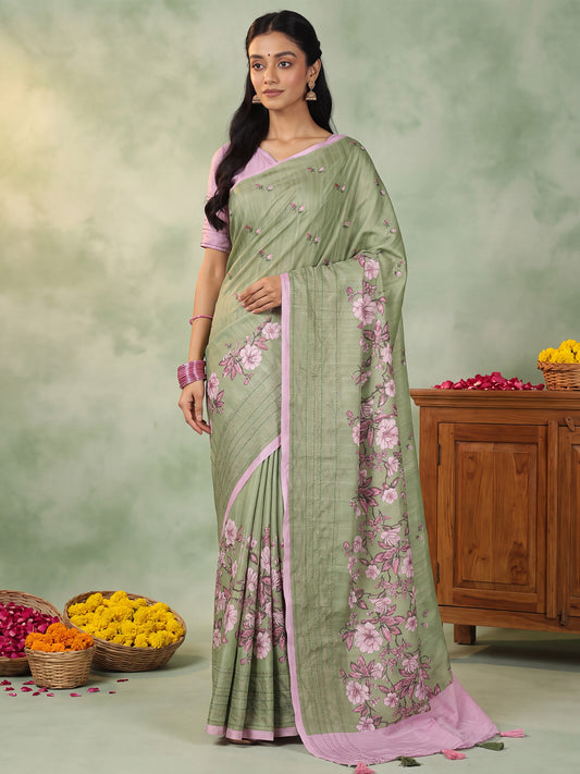 Woman wearing light green silk blend saree with all-over floral design and pink blouse
