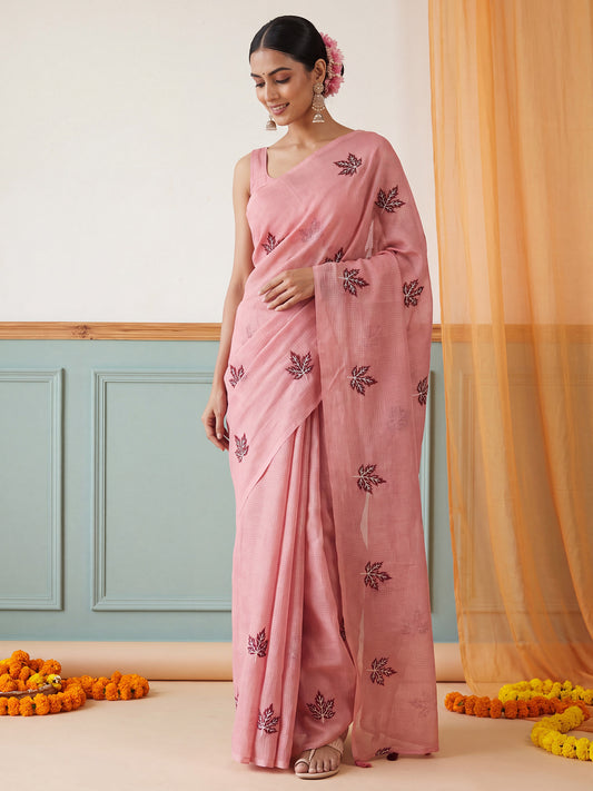 Woman wearing peach kota doria cotton saree with embroidered motif work and peach blouse