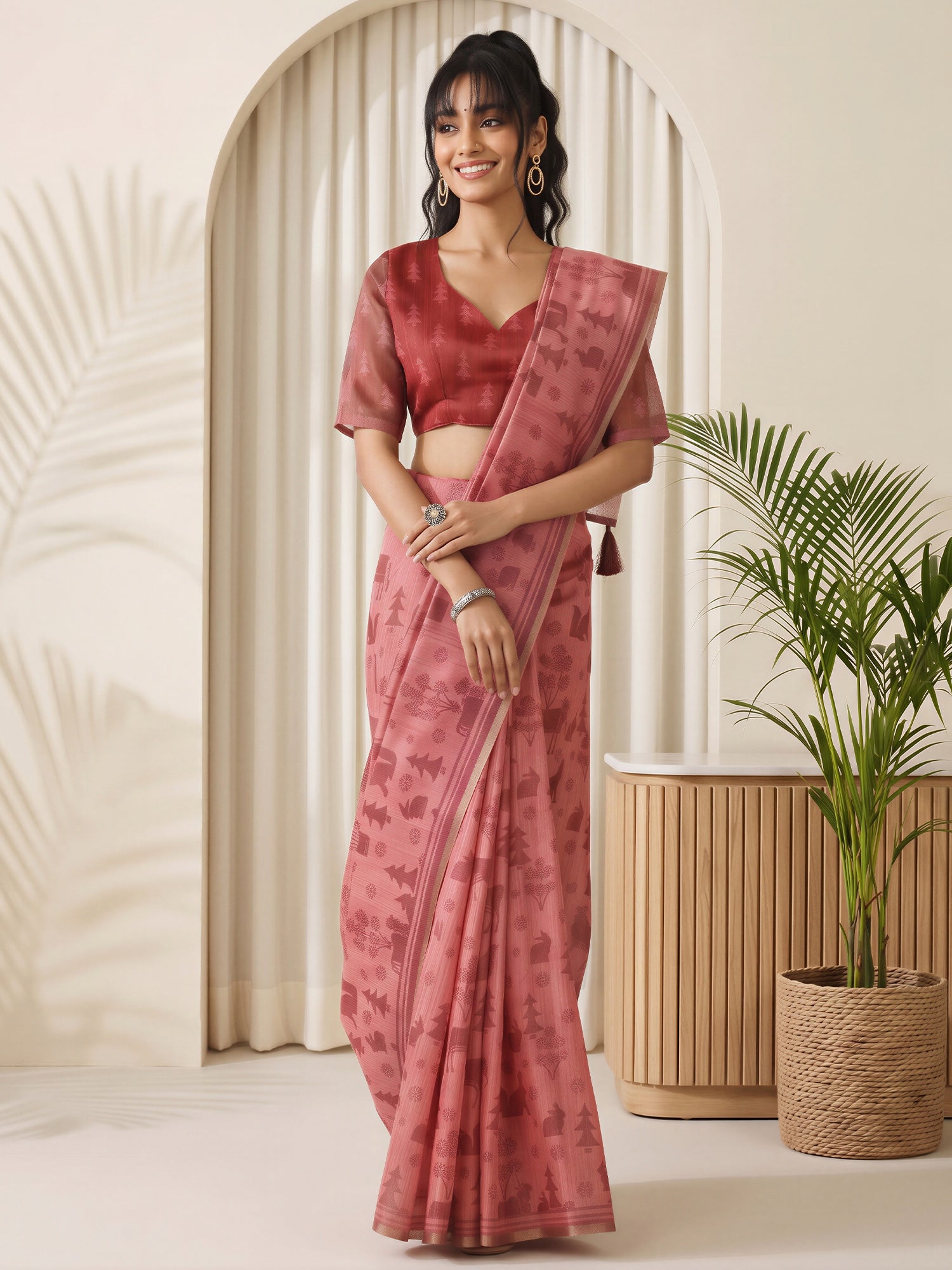 Woman wearing peach cotton linen saree with traditional indian motif work and peach blouse