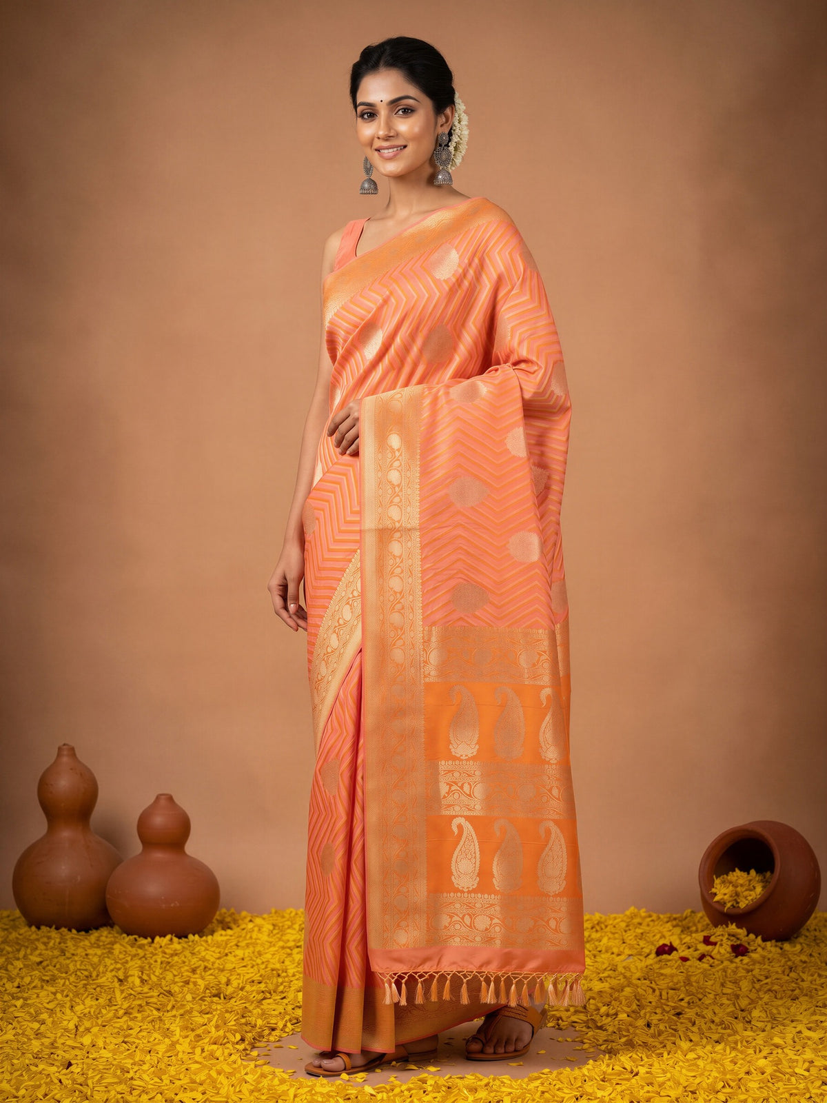 Woman wearing peach silk blend saree with geometric pattern design and peach blouse