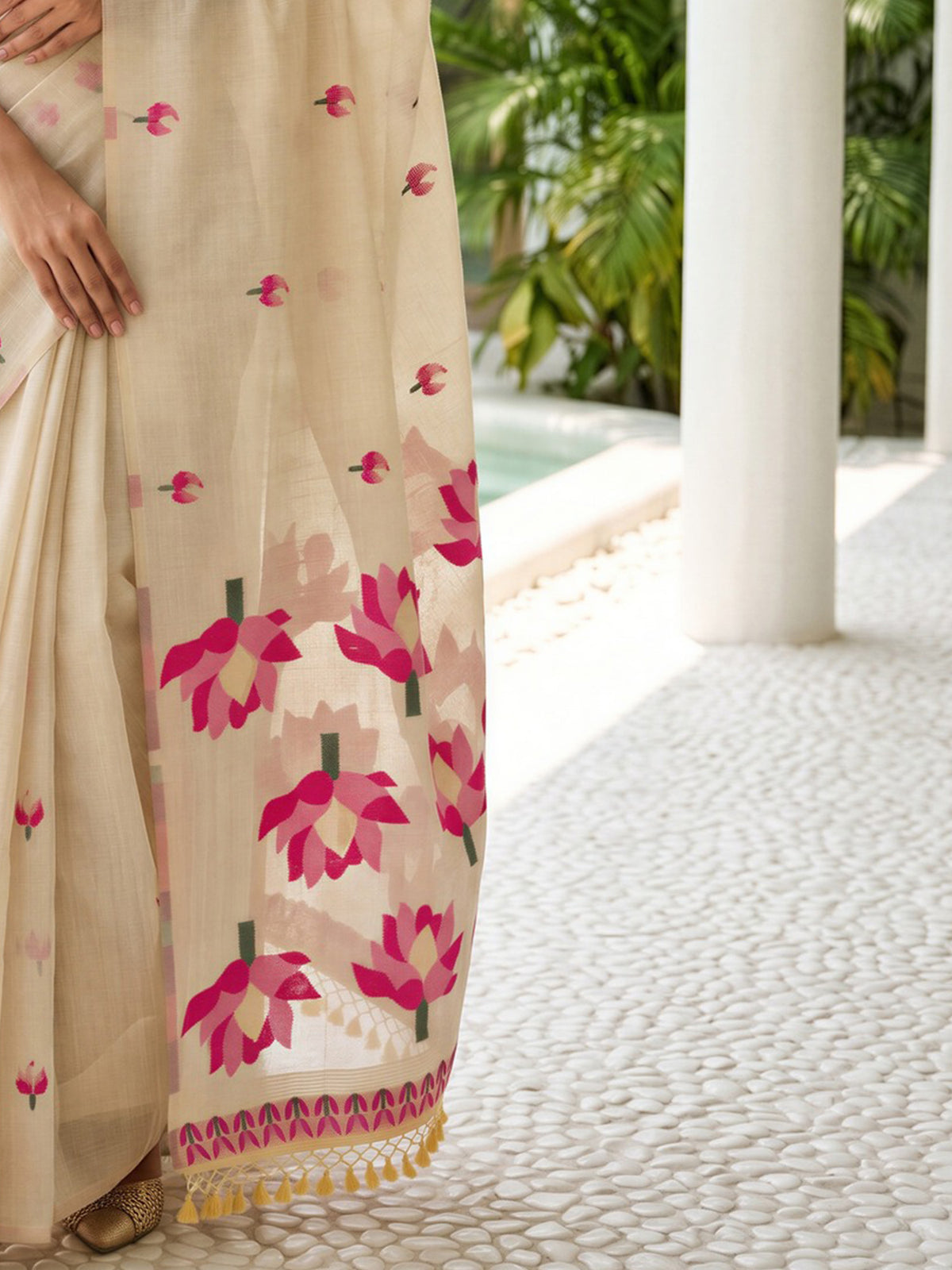 Pallu detail of cream chanderi cotton saree showing all-over floral design and embellished border