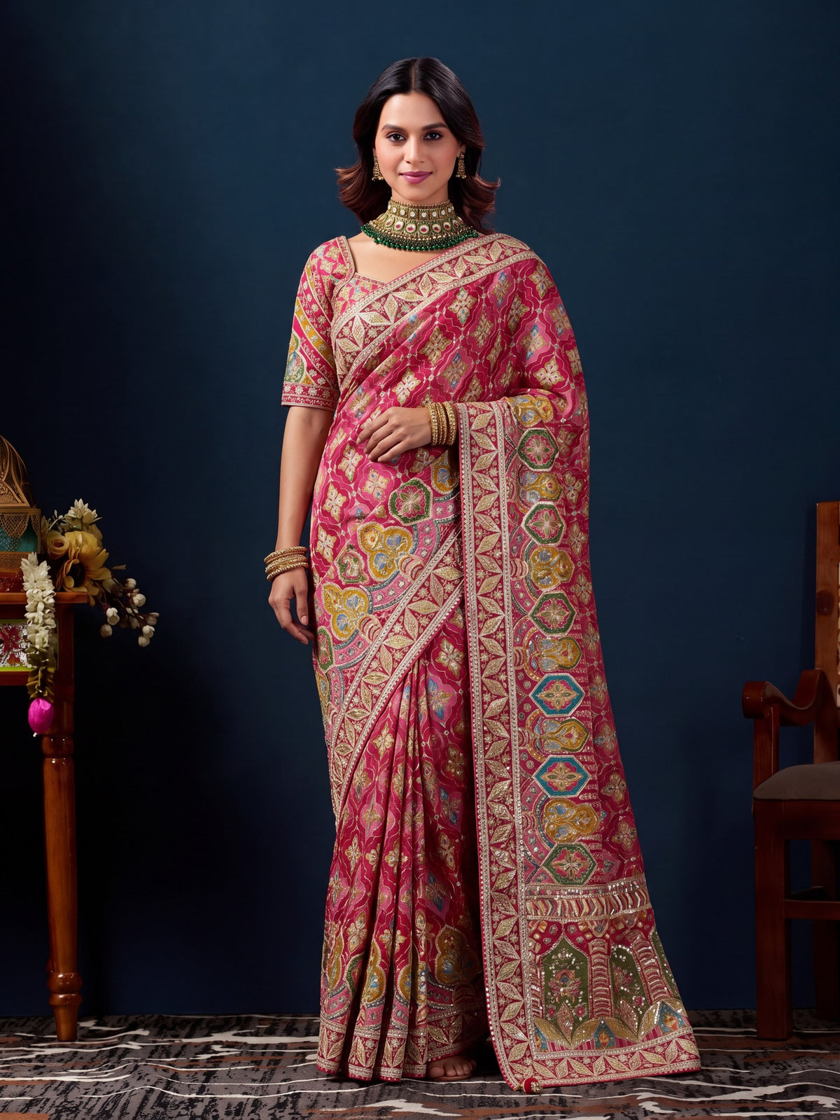 Woman wearing pink silk blend saree with traditional indian motif work and pink blouse