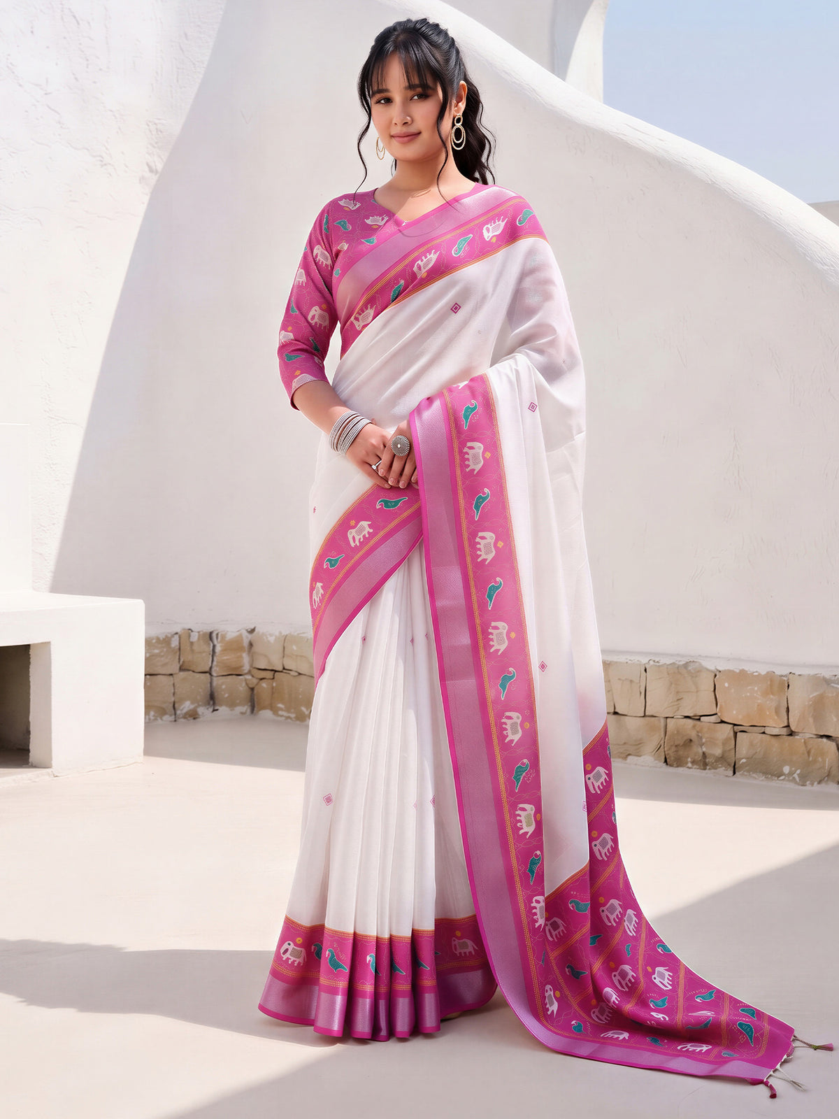 Woman wearing white cotton linen saree with traditional indian motif work and pink blouse