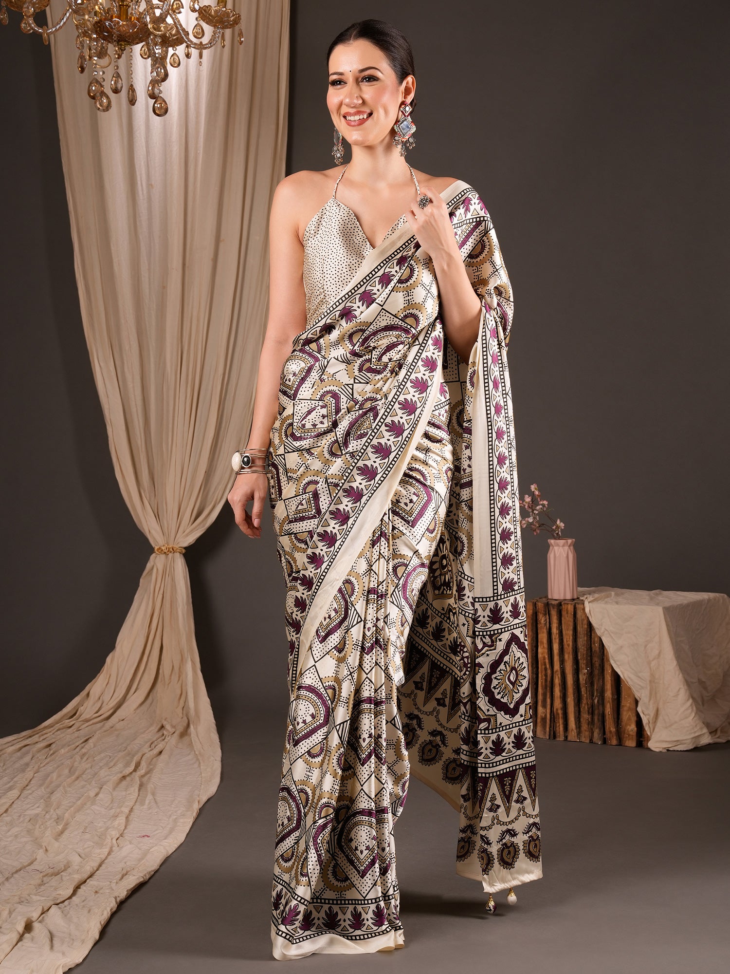 Woman wearing off white satin saree with ajrak block-print motif work and off white blouse