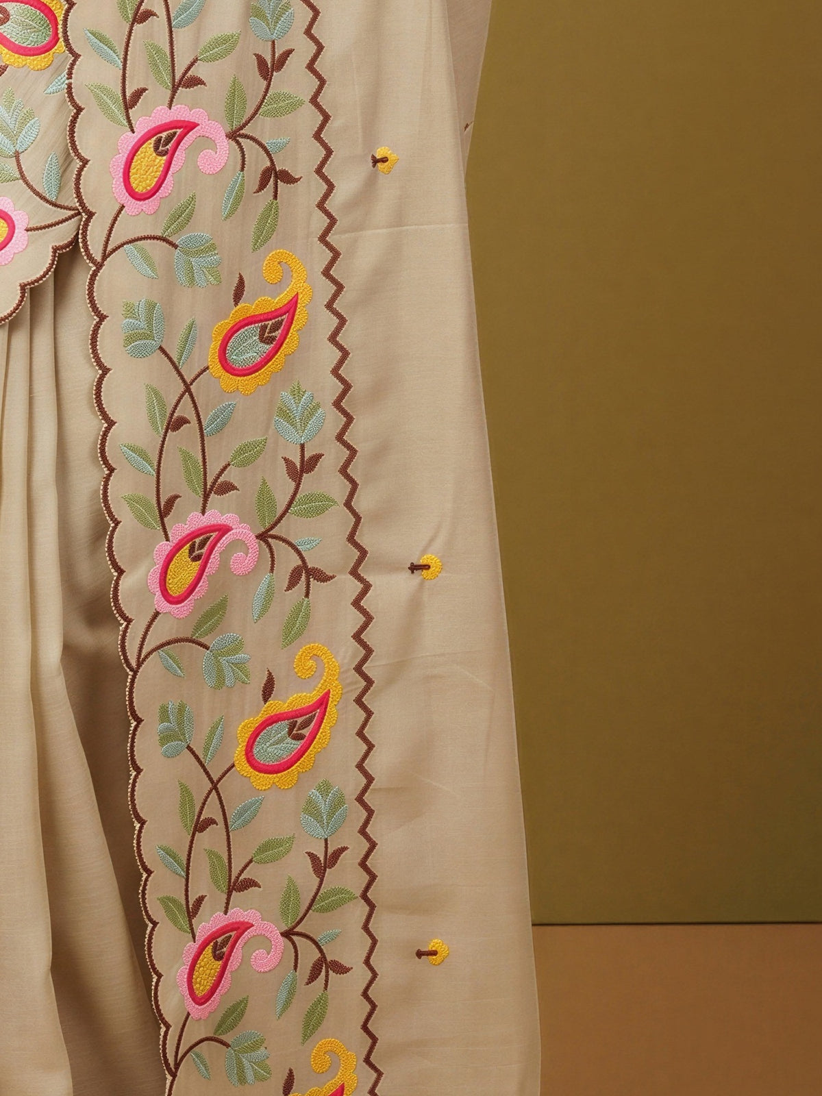 Pallu detail of beige georgette saree showing embroidered motif work and embroidered border