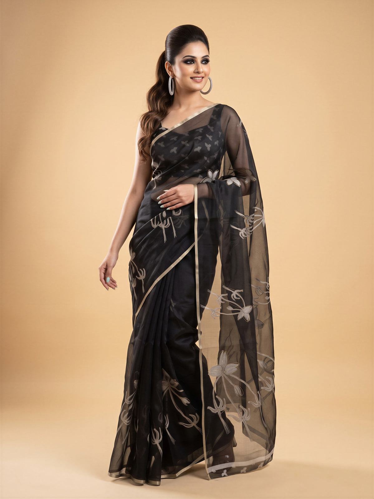 Woman wearing black organza saree with abstract contemporary design and black blouse
