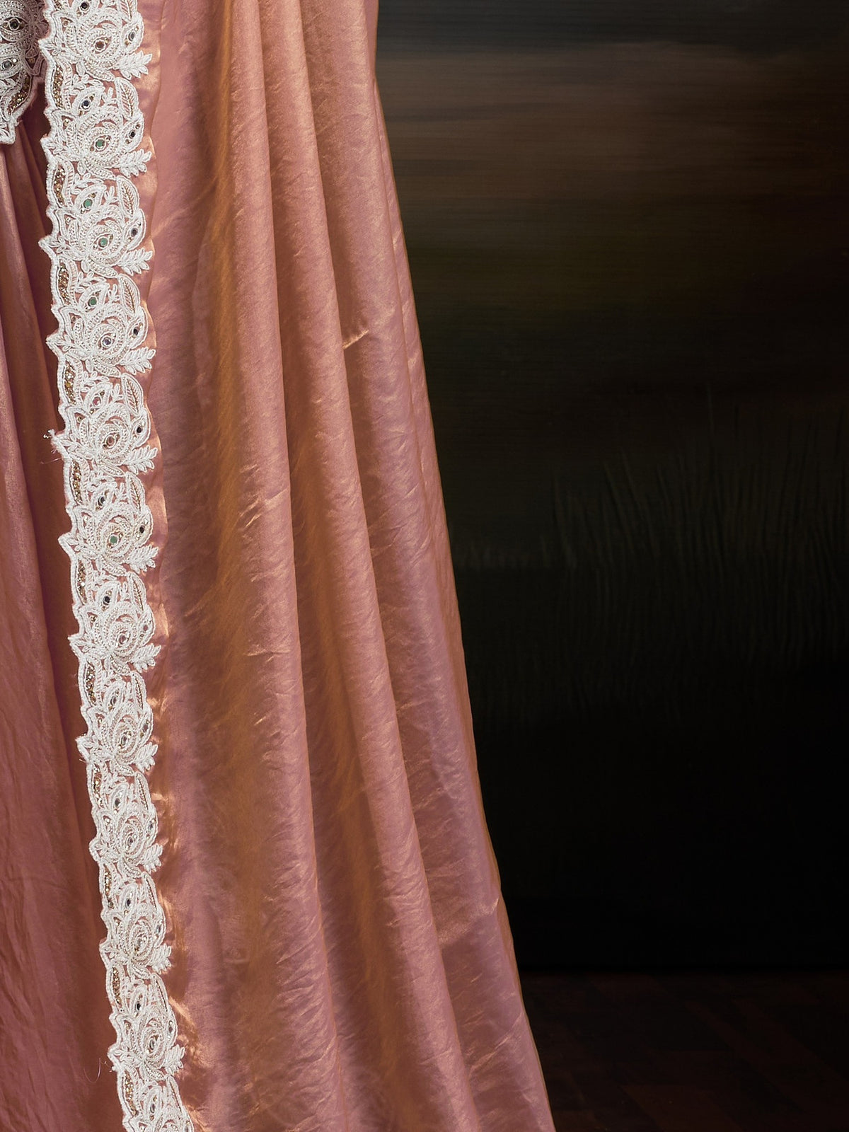 Pallu detail of peach satin silk saree showing clean solid-tone finish and scallop border