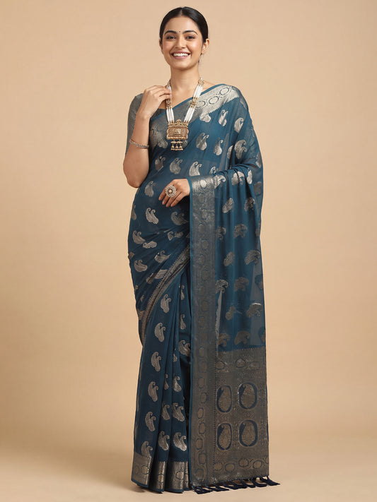 Woman wearing teal blue georgette saree with zari butta (metallic motif) work and teal blue blouse
