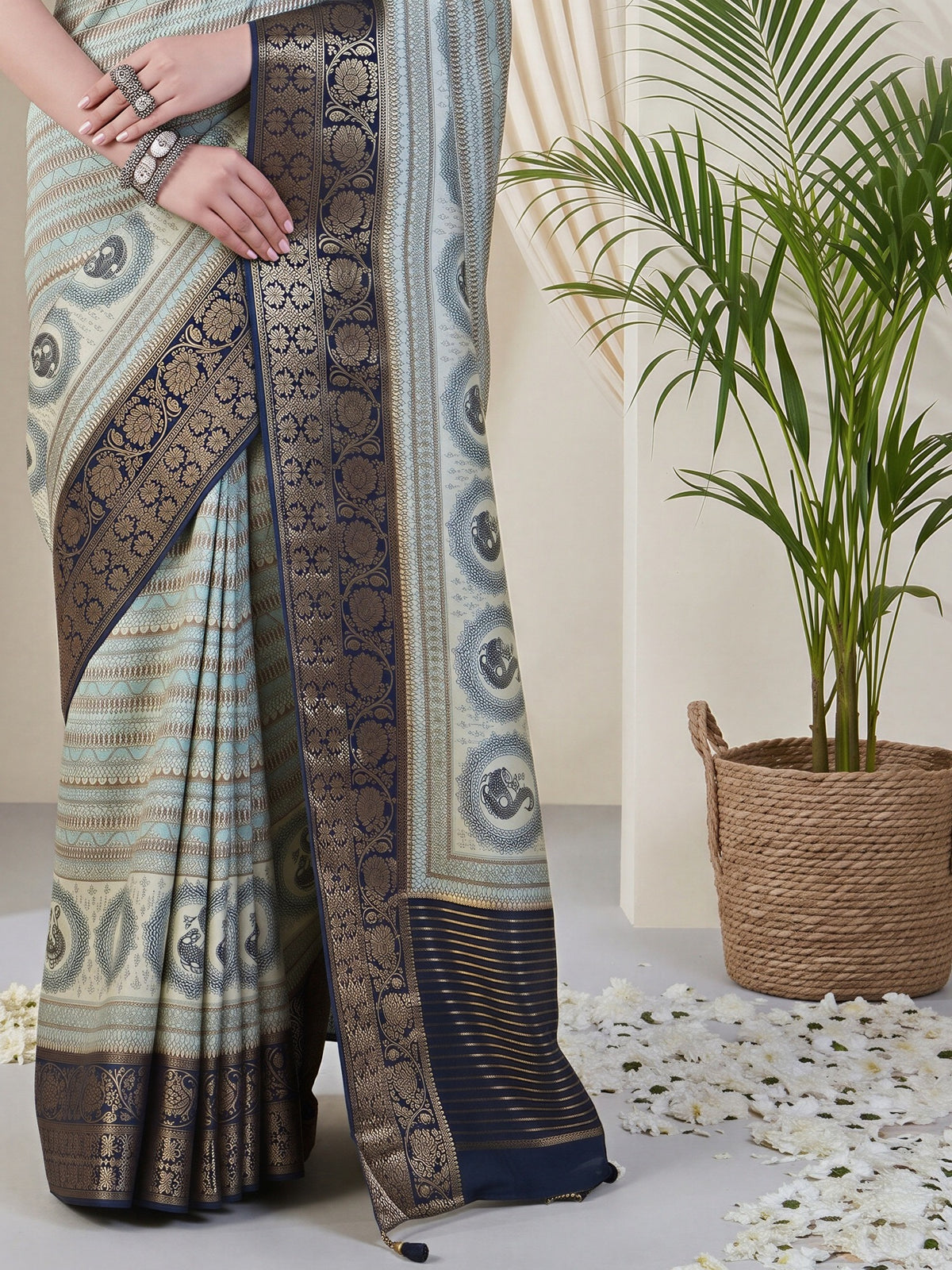 Pallu detail of light blue viscose silk saree showing traditional indian motif work and zari border