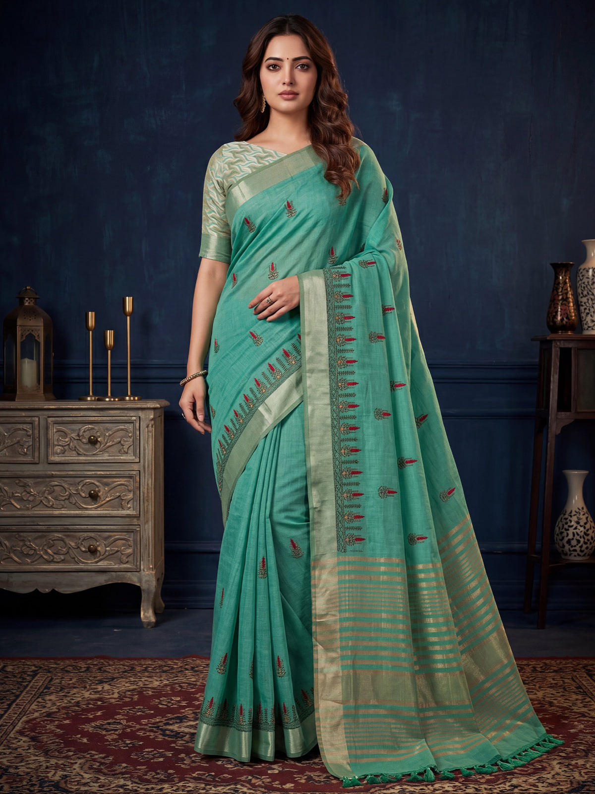 Woman wearing sea green cotton linen saree with embroidered motif work and sea green blouse