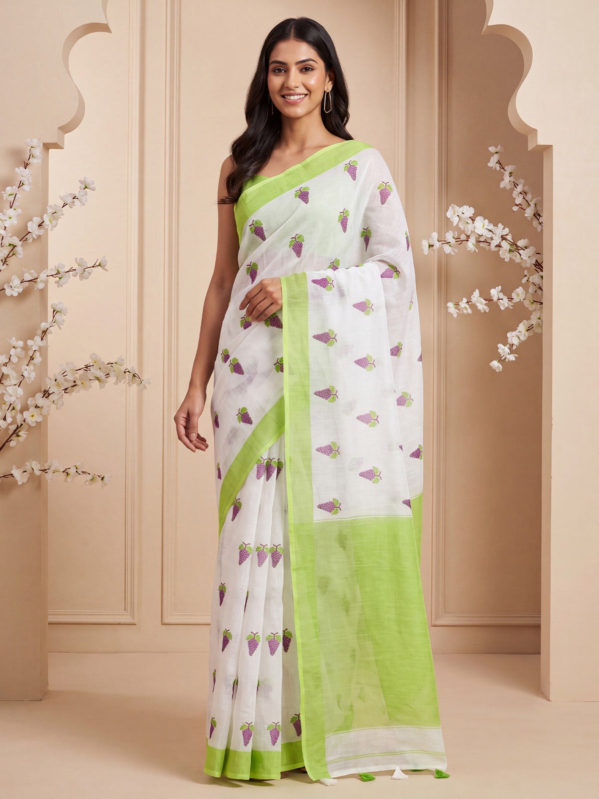 Woman wearing lime green cotton linen saree with quirky design and lime green blouse