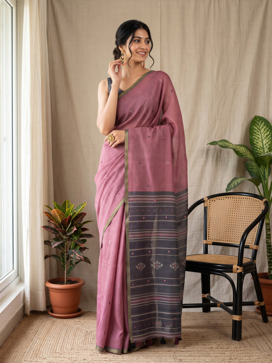 Woman wearing wine linen blend saree with traditional indian motif work and black blouse