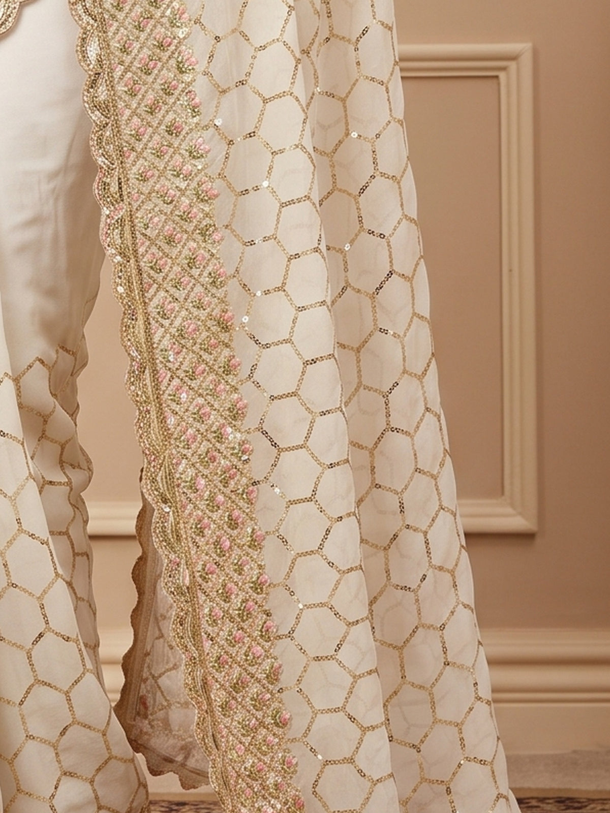 Pallu detail of offwhite georgette saree showing ornamented surface design and embellished border
