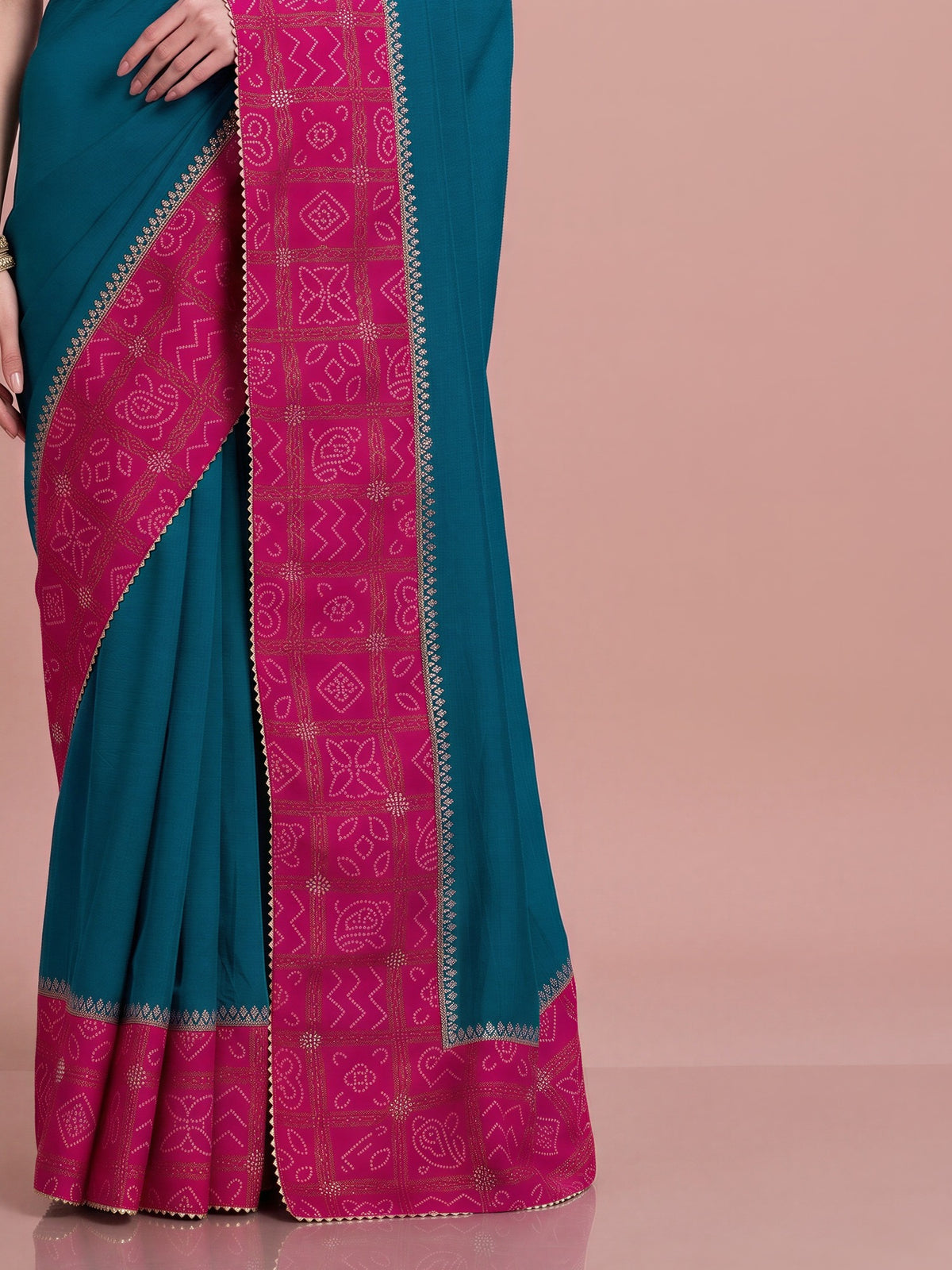 Pallu detail of teal blue vichitra silk saree showing bandhani tie-dye dot work and embellished border