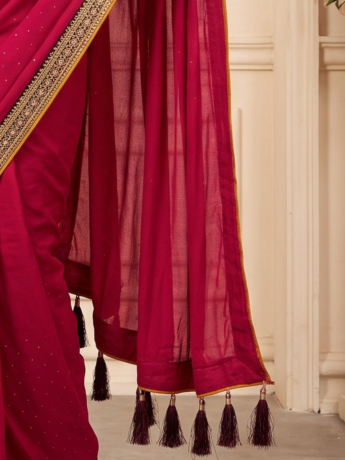 Pallu detail of pink vichitra silk saree showing ornamented surface design and embellished border
