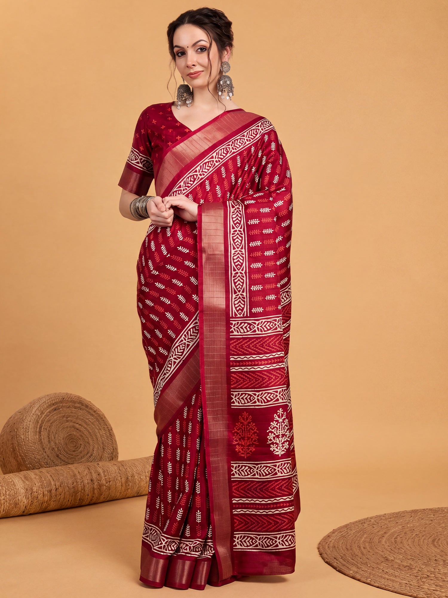 Woman wearing red silk blend saree with traditional indian motif work and red blouse