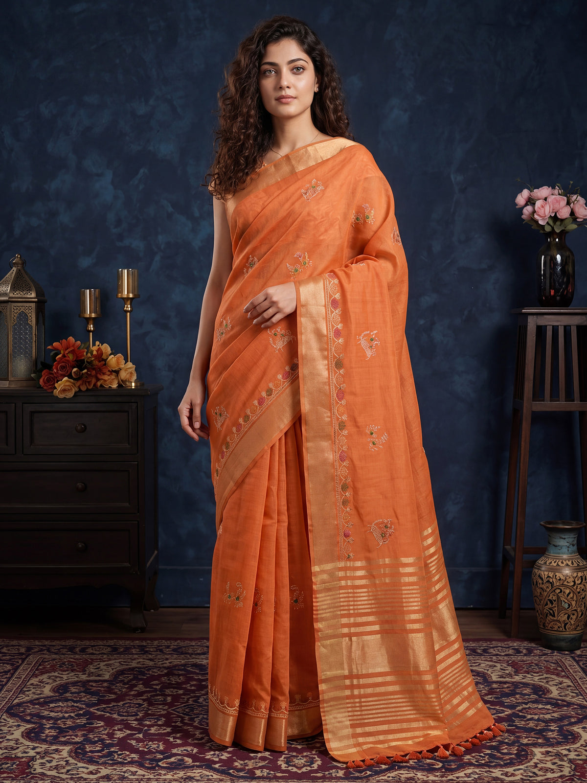 Woman wearing orange cotton linen saree with embroidered motif work and orange blouse