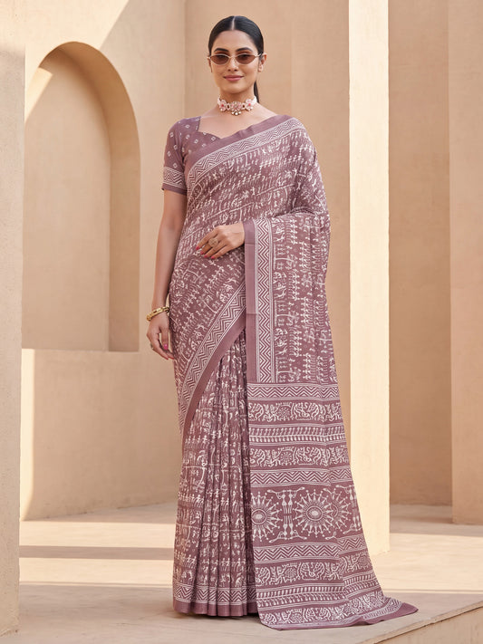 Woman wearing mauve dola silk saree with warli folk-art figures and mauve blouse