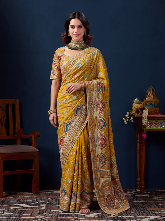 Woman wearing yellow silk blend saree with traditional indian motif work and yellow blouse