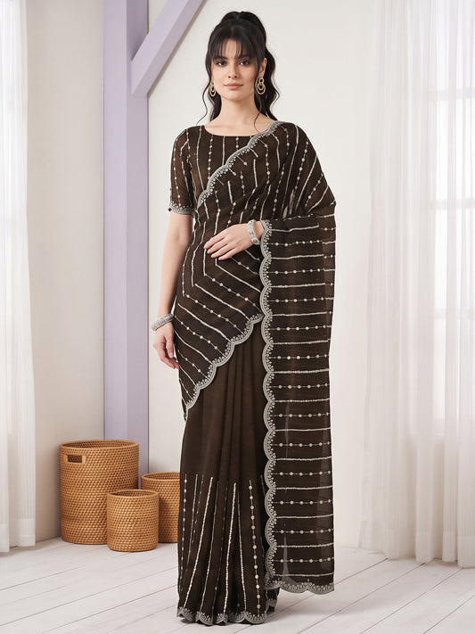 Woman wearing olive chiffon saree with striped pattern design and olive blouse