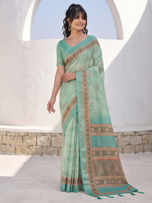 Woman wearing mint green cotton silk saree with traditional indian motif work and mint green blouse