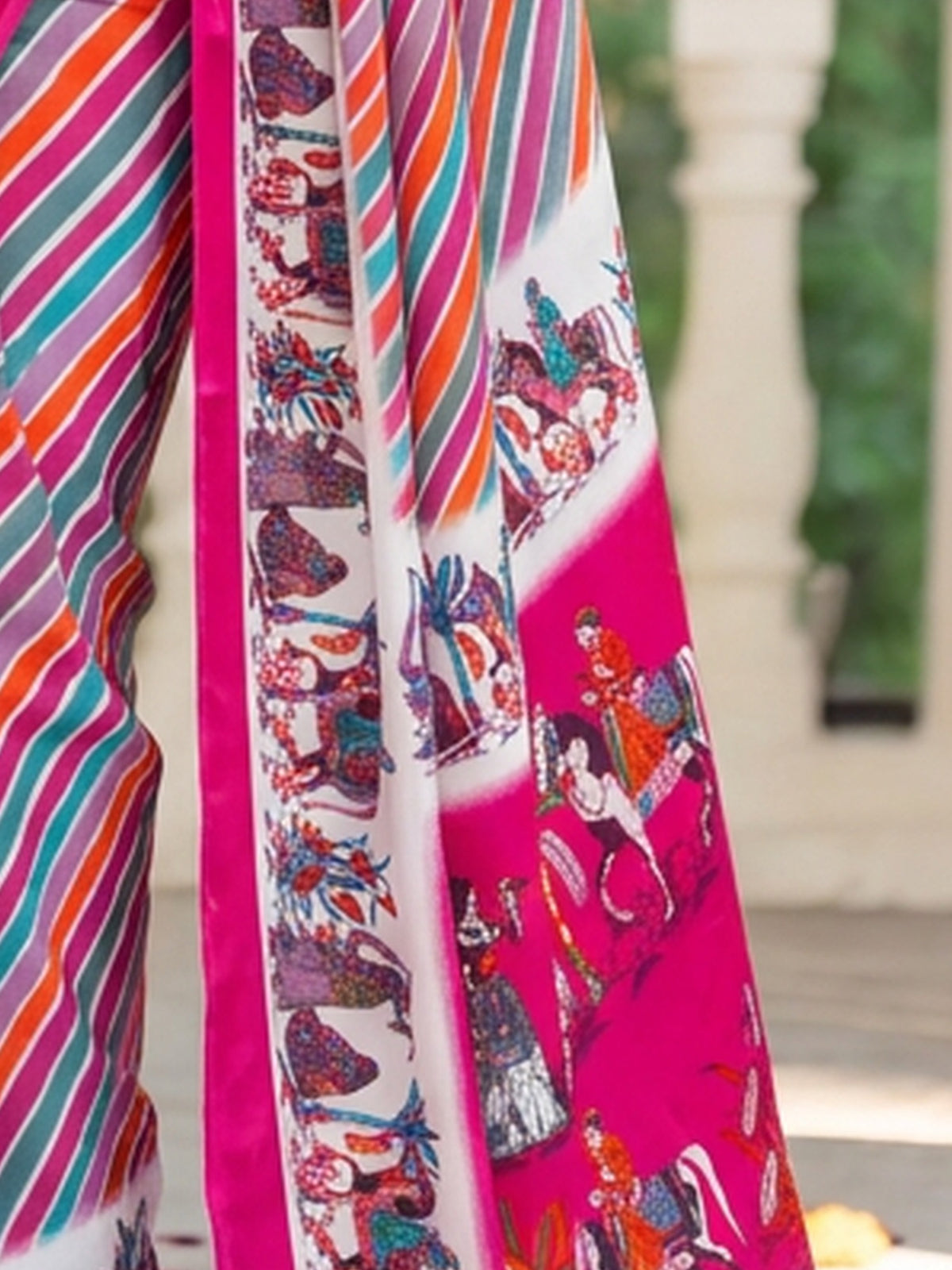 Pallu detail of pink crepe saree showing striped pattern design and printed border