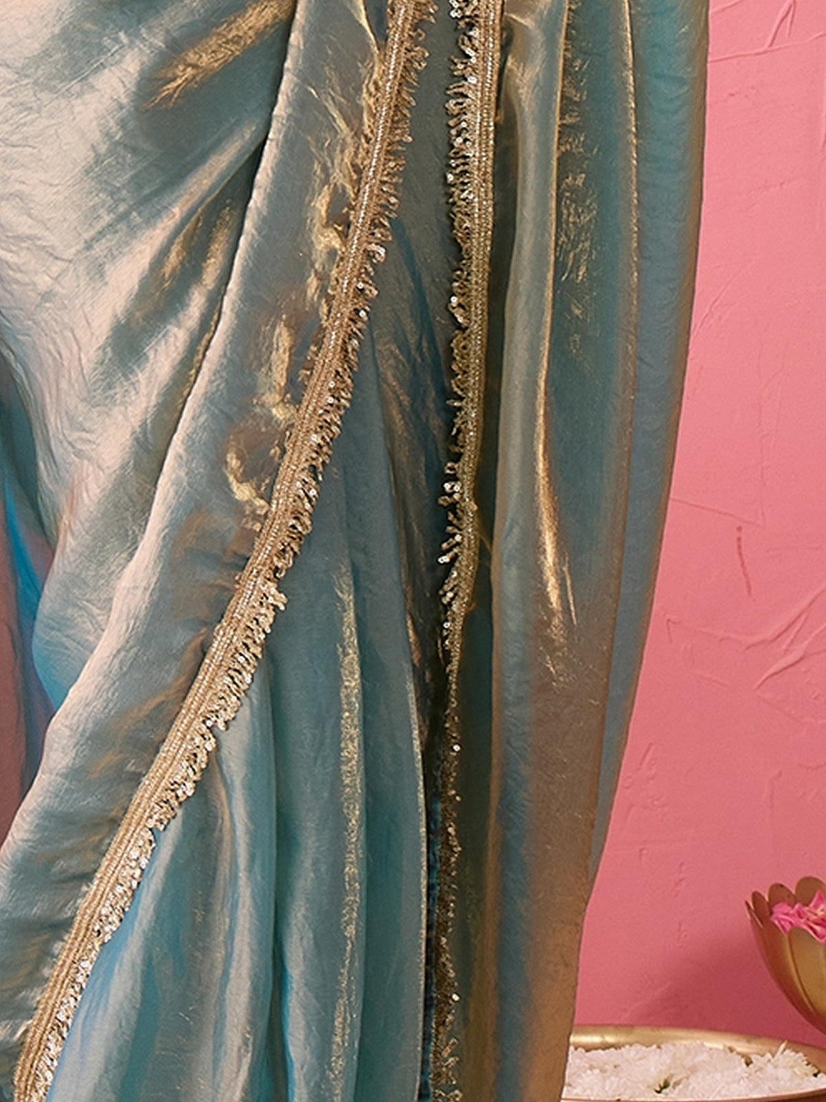 Pallu detail of teal blue paper silk saree showing ornamented surface design and embellished border