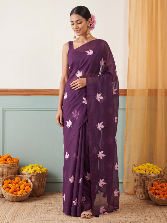 Woman wearing wine kota doria cotton saree with embroidered motif work and wine blouse