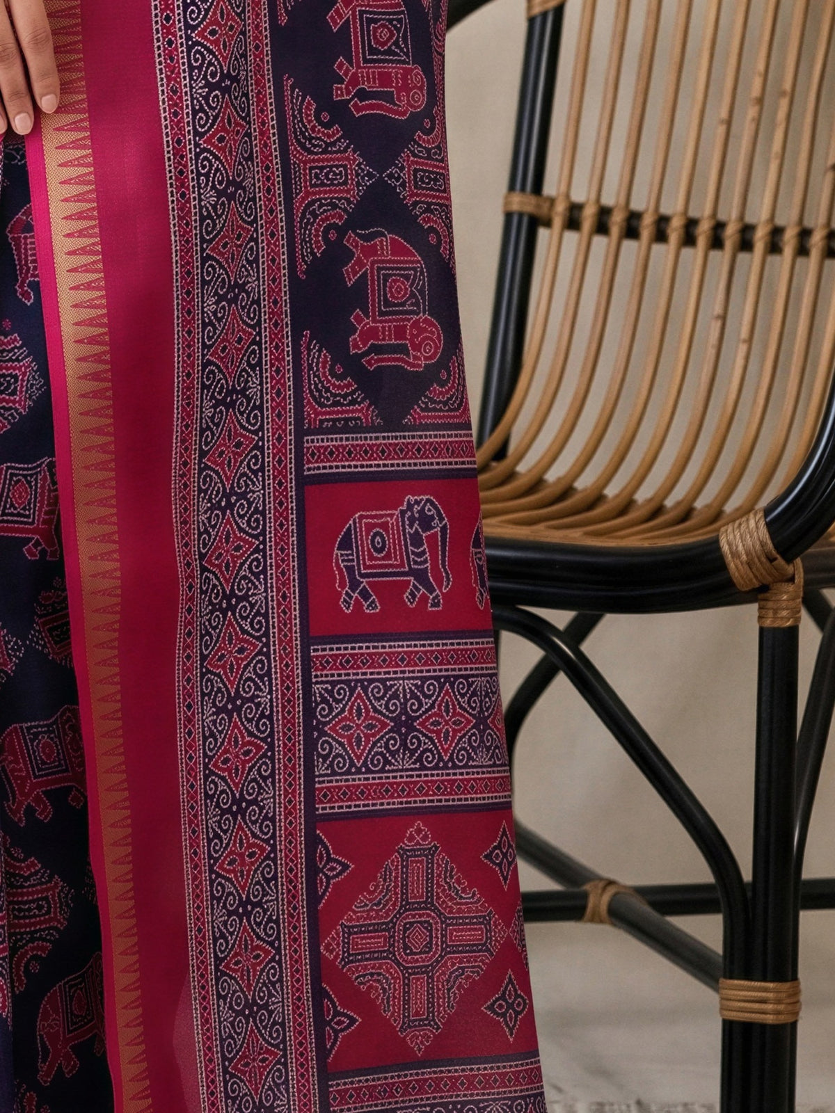 Pallu detail of navy blue georgette saree showing traditional indian motif work and zari border