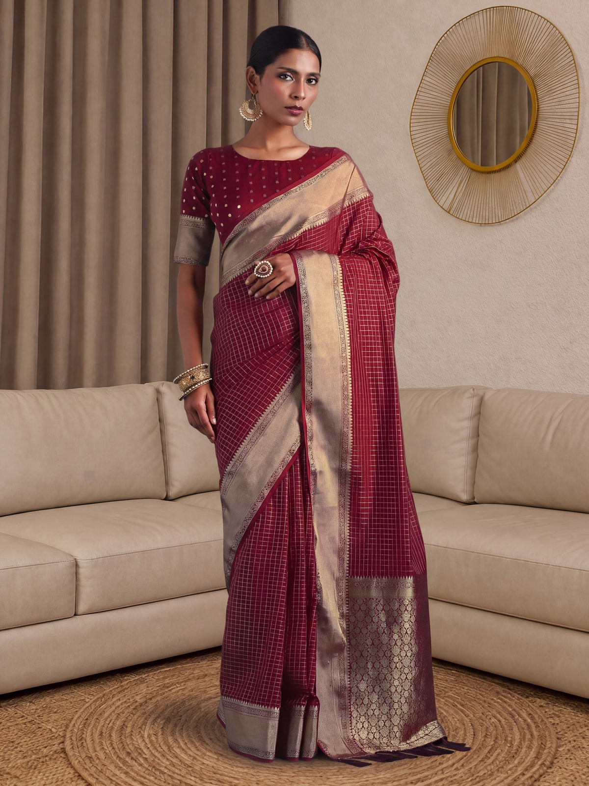Woman wearing maroon banarasi silk saree with checked pattern design and maroon blouse
