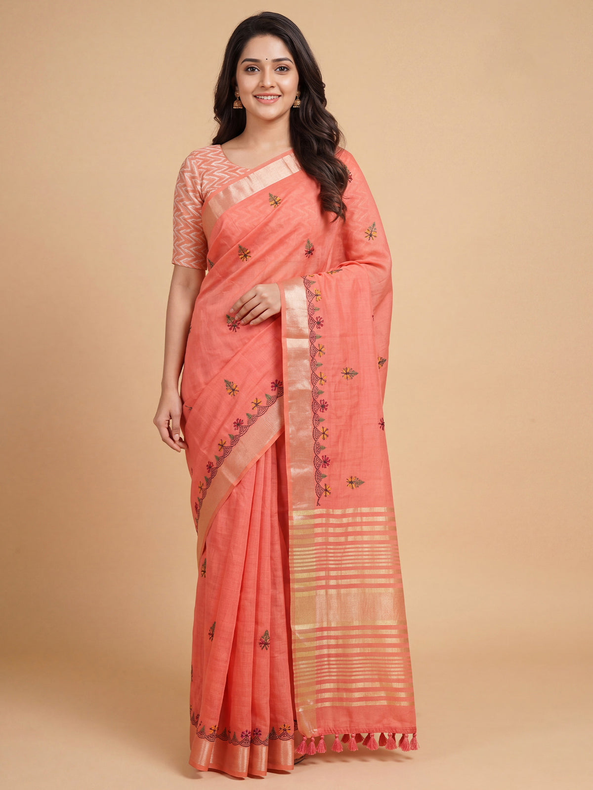 Woman wearing peach cotton linen saree with embroidered motif work and peach blouse