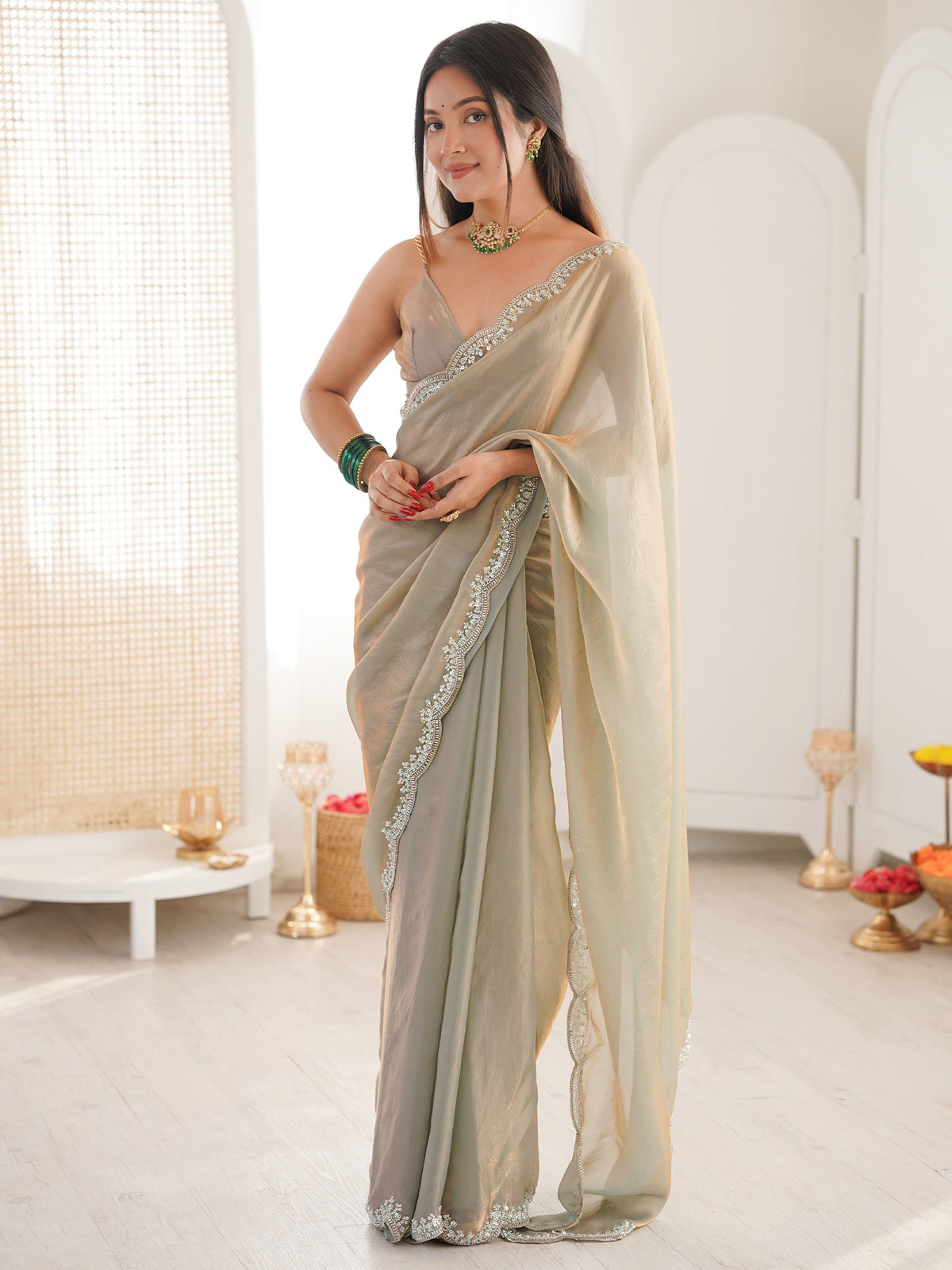 Woman wearing metallic silk blend saree with clean solid-tone finish and metallic blouse