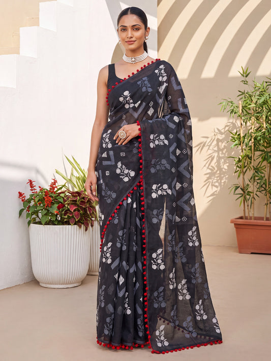 Woman wearing black cotton saree with chevron zigzag pattern and black blouse