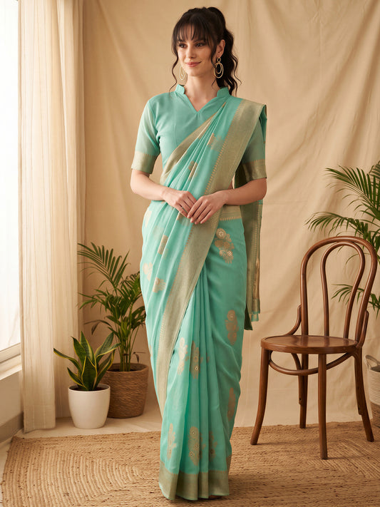Woman wearing teal green silk blend saree with all-over floral design and teal green blouse