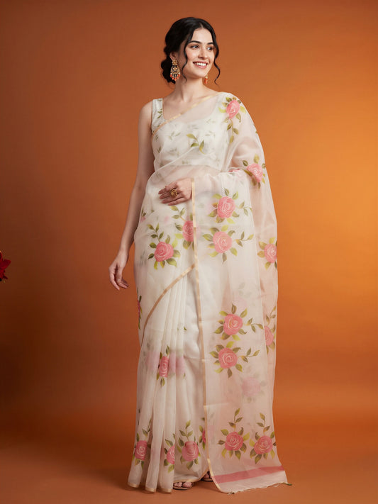 Woman wearing white organza saree with all-over floral design and white blouse