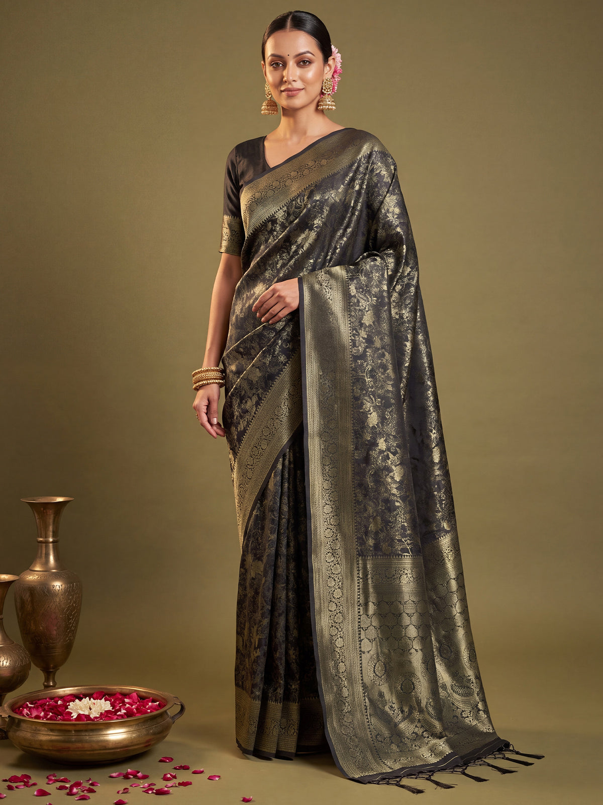 Woman wearing black kanjeevaram silk saree with traditional indian motif work and black blouse