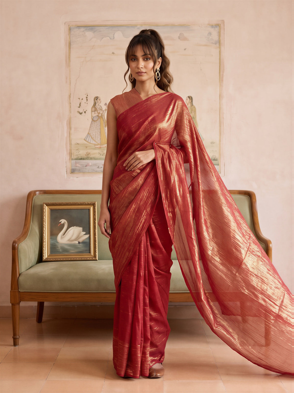 Woman wearing orange tissue saree with clean solid-tone finish and orange blouse