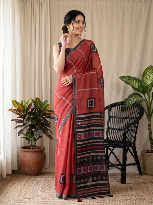 Woman wearing rust linen blend saree with geometric pattern design and black blouse