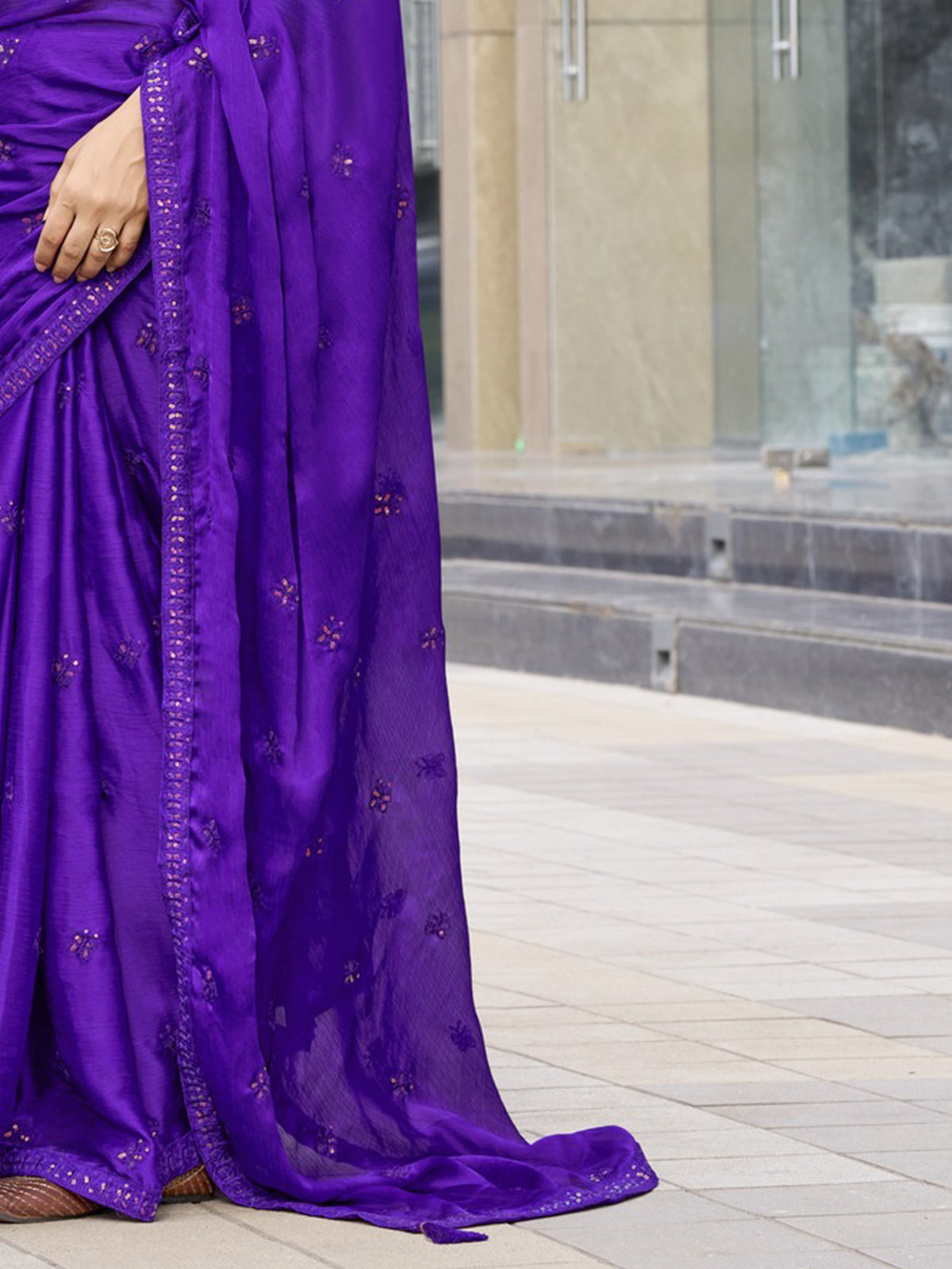 Pallu detail of purple satin silk saree showing ornamented surface design and embellished border