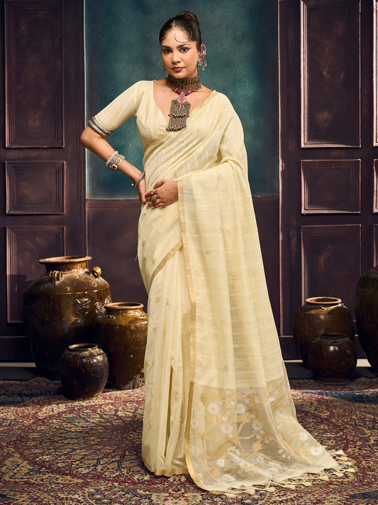 Woman wearing cream muga cotton saree with zari butta (metallic motif) work and cream blouse