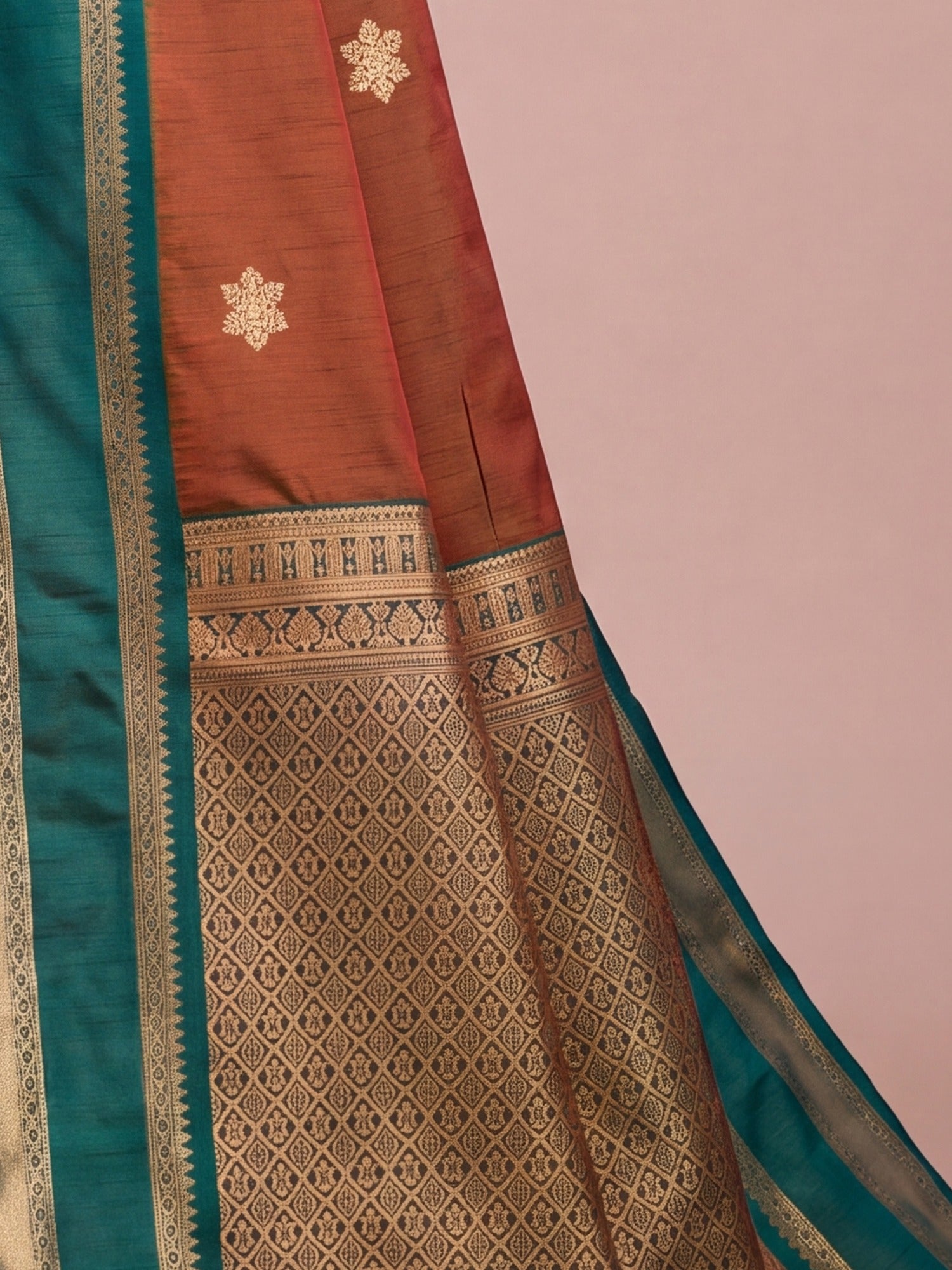 Pallu detail of rust tussar silk saree showing traditional indian motif work and zari border