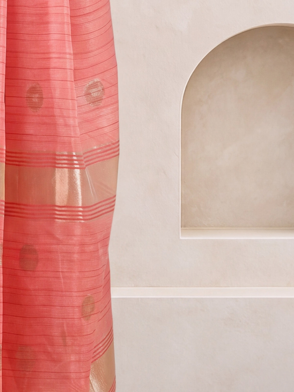 Pallu detail of pink linen saree showing zari butta (metallic motif) work and zari border